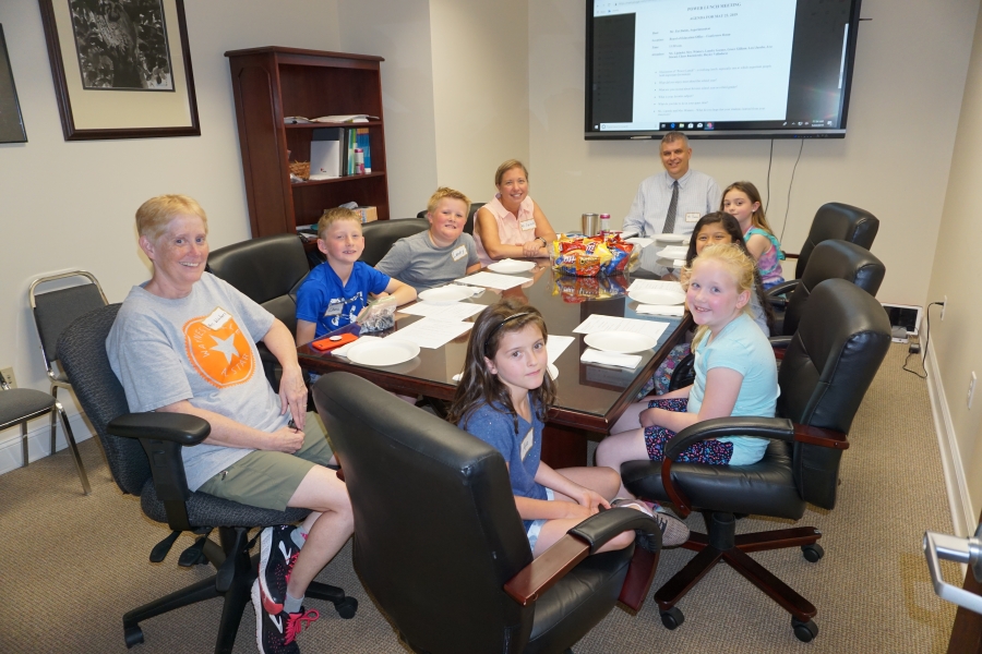 group of people around a board table